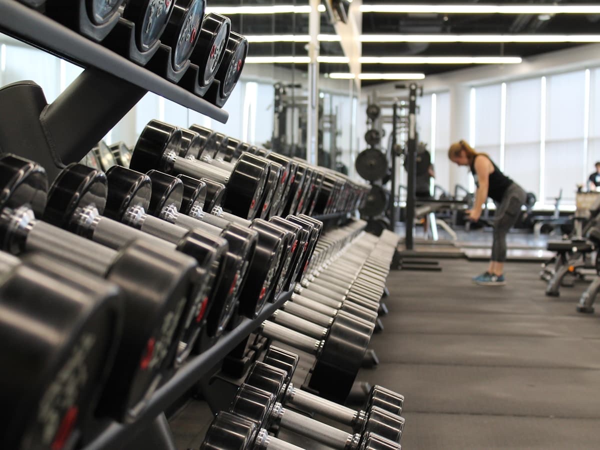 Athletic man lifting weights with focus